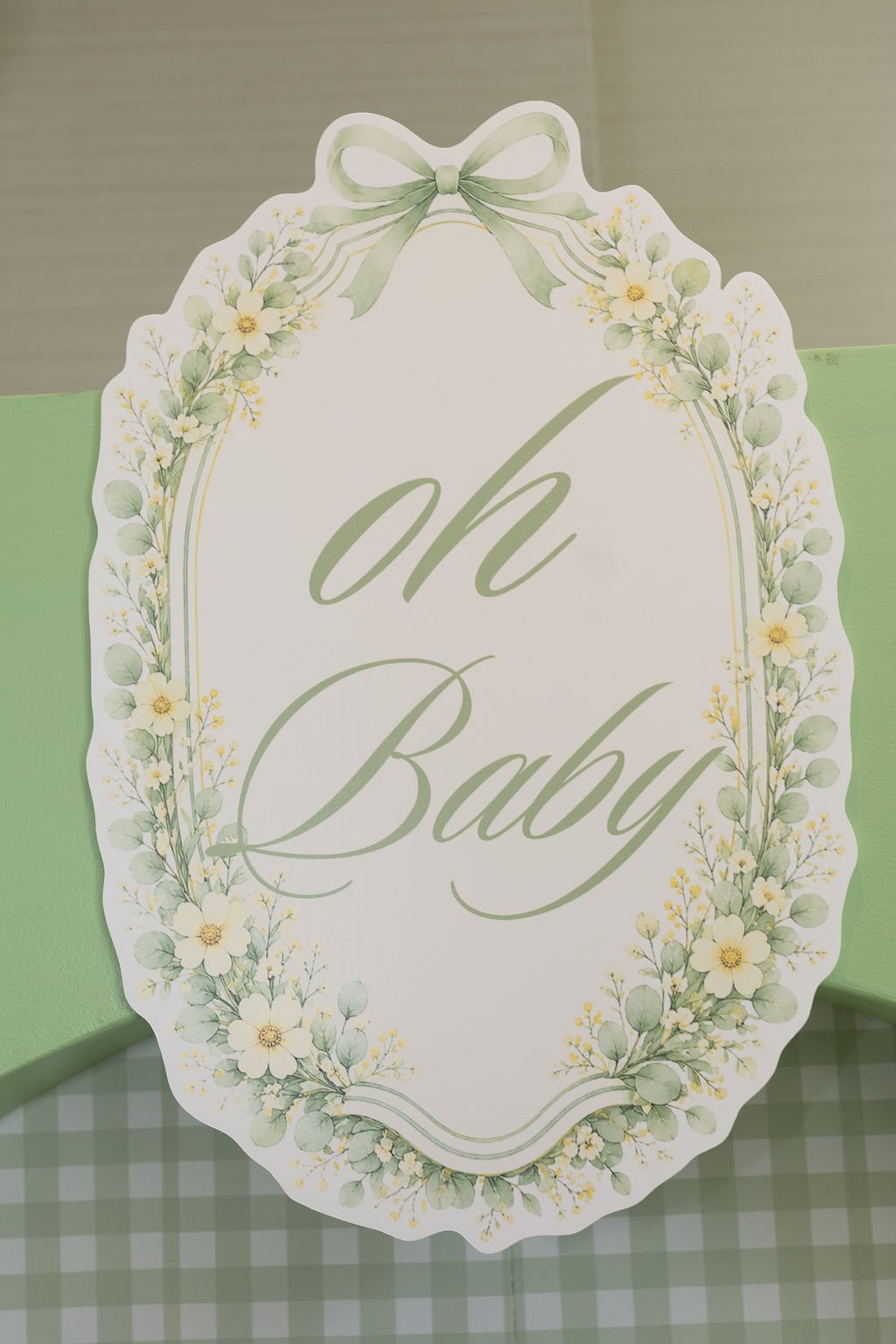 Close-up of the floral 'oh Baby' welcome sign