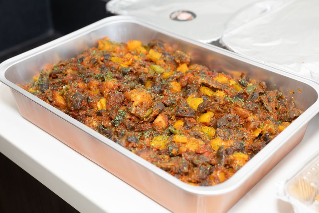 Tray of jollof rice with mixed vegetables at the catering table