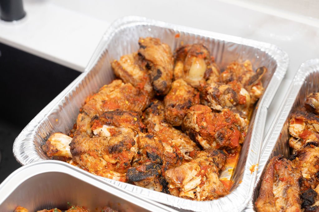 Trays of fried chicken at the catering table