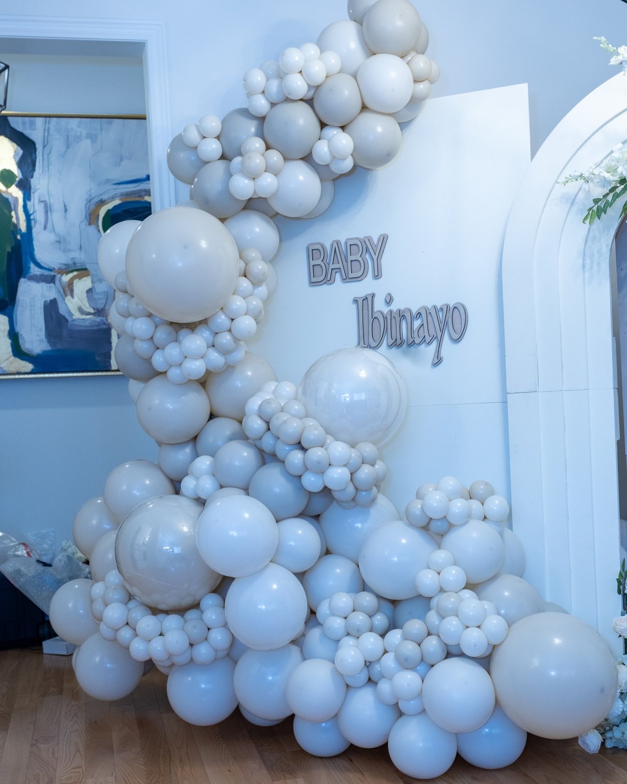 Organic balloon garland installation with a Baby Ibinayo sign