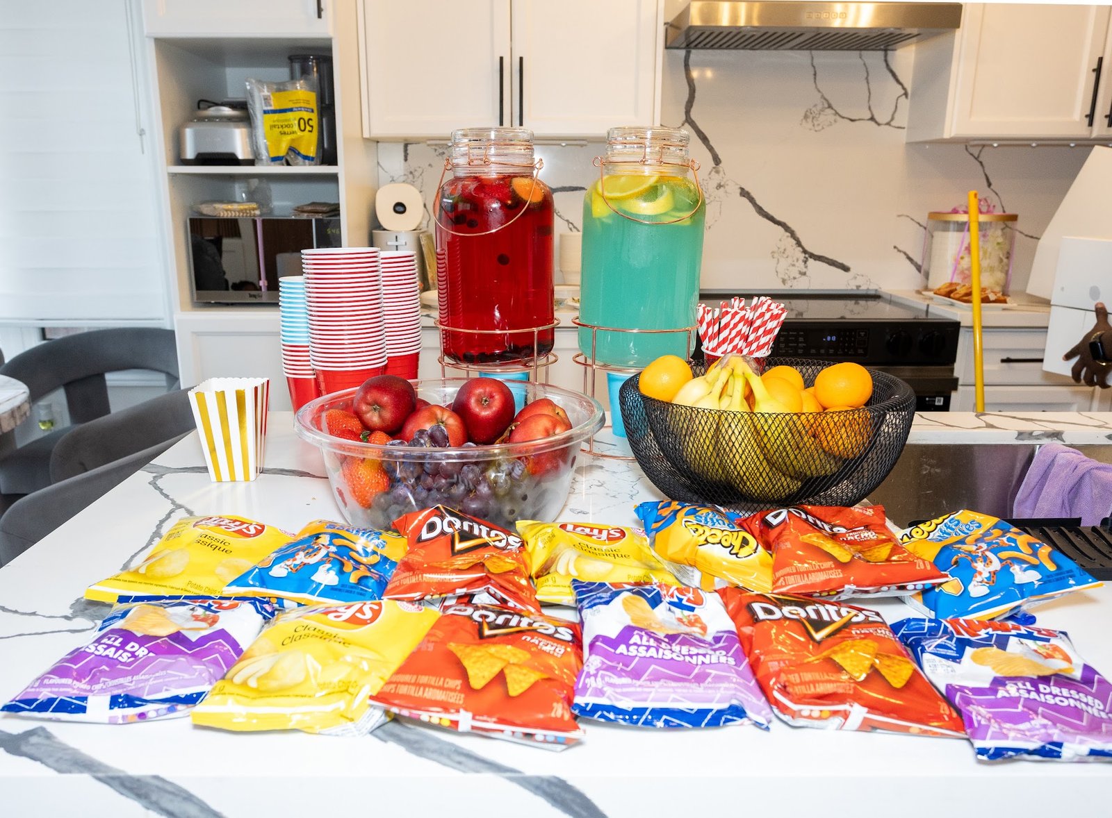 Drink dispensers and snack spread styled on the kitchen island