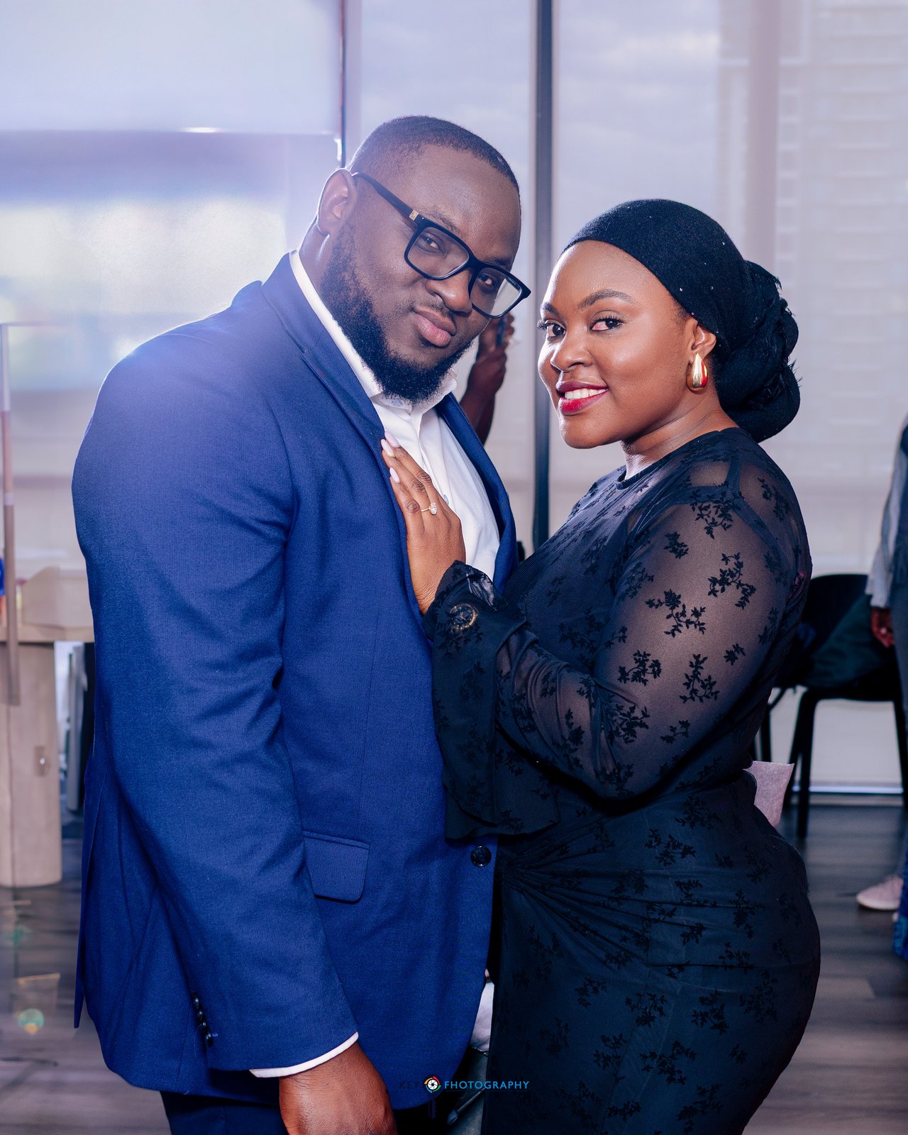 The newly engaged couple smiling together in a candid portrait