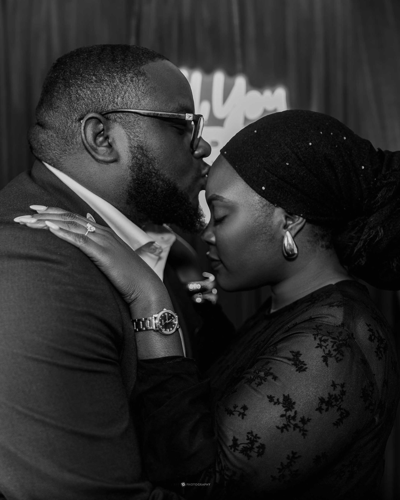 The couple sharing a tender kiss, captured in black and white