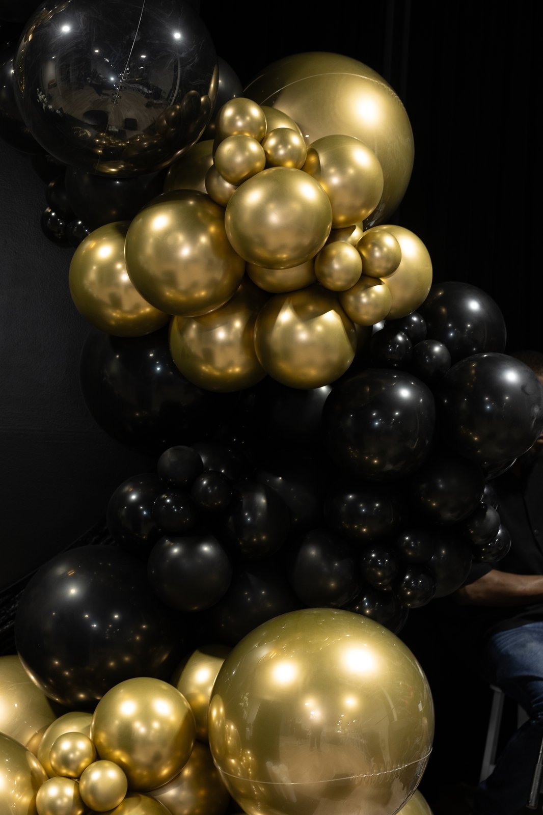 Organic black and gold balloon garland installation