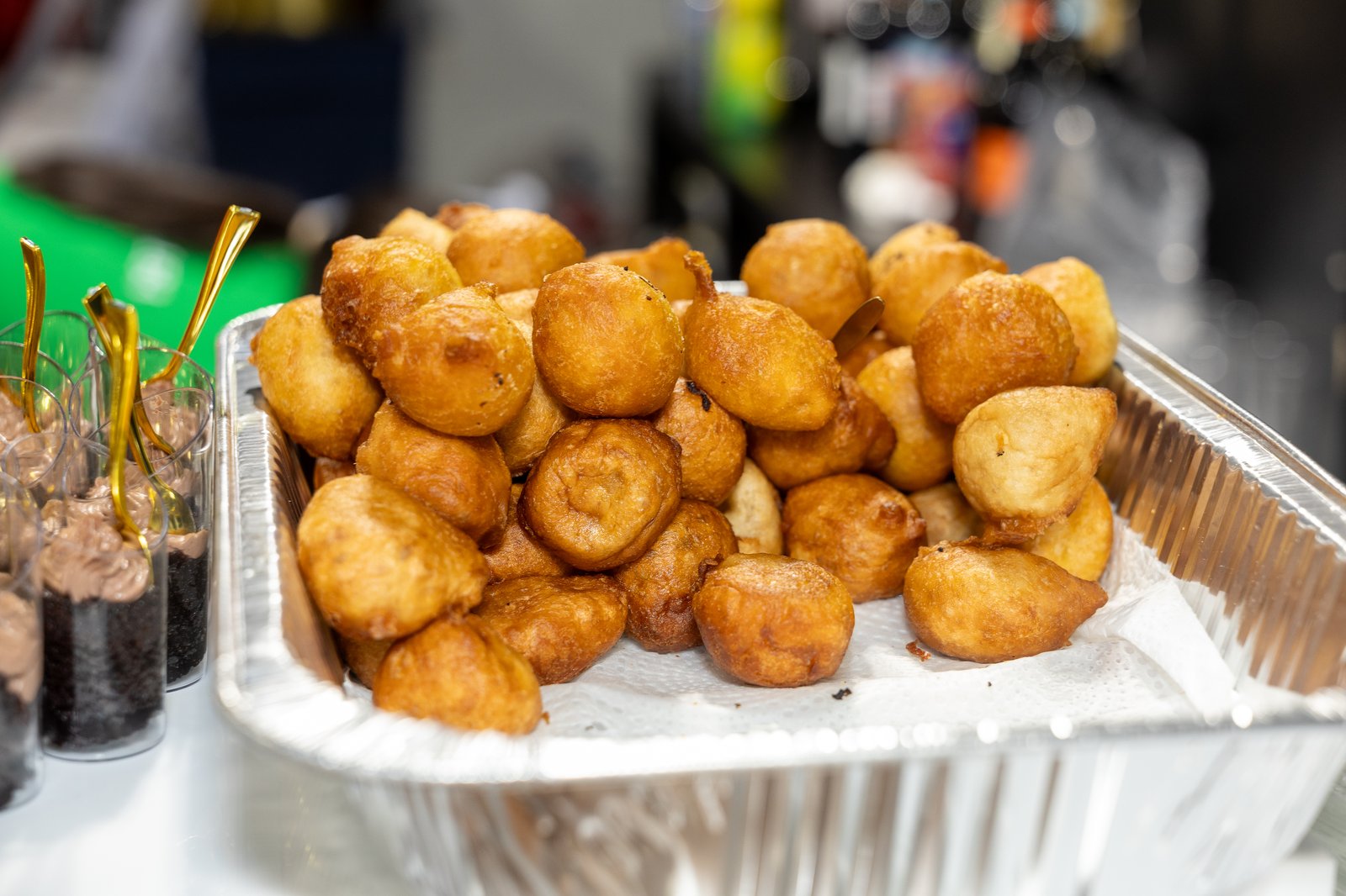 Puff-puff and skewered dessert cups on a serving tray