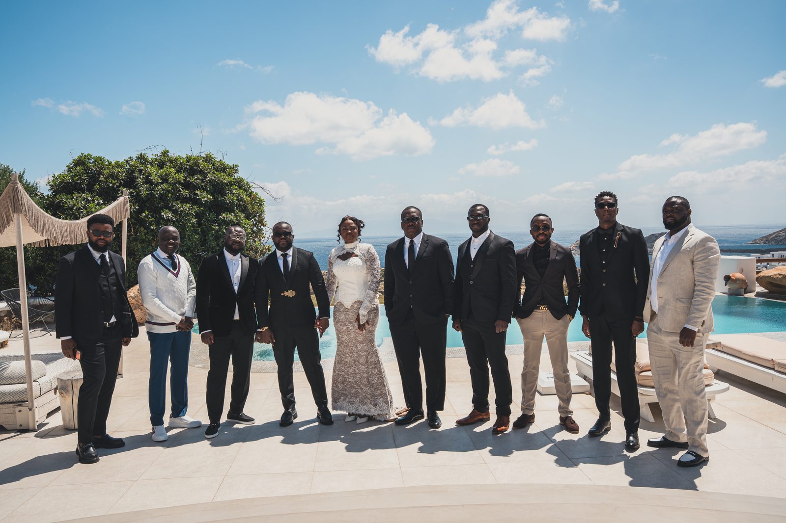 The couple with their groomsmen by the pool