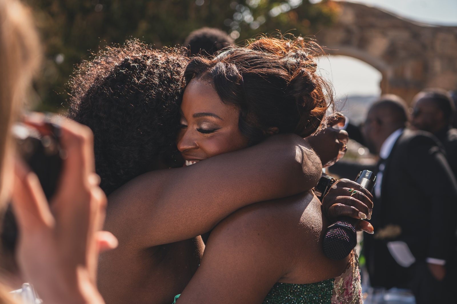 A warm embrace between the bride and a guest