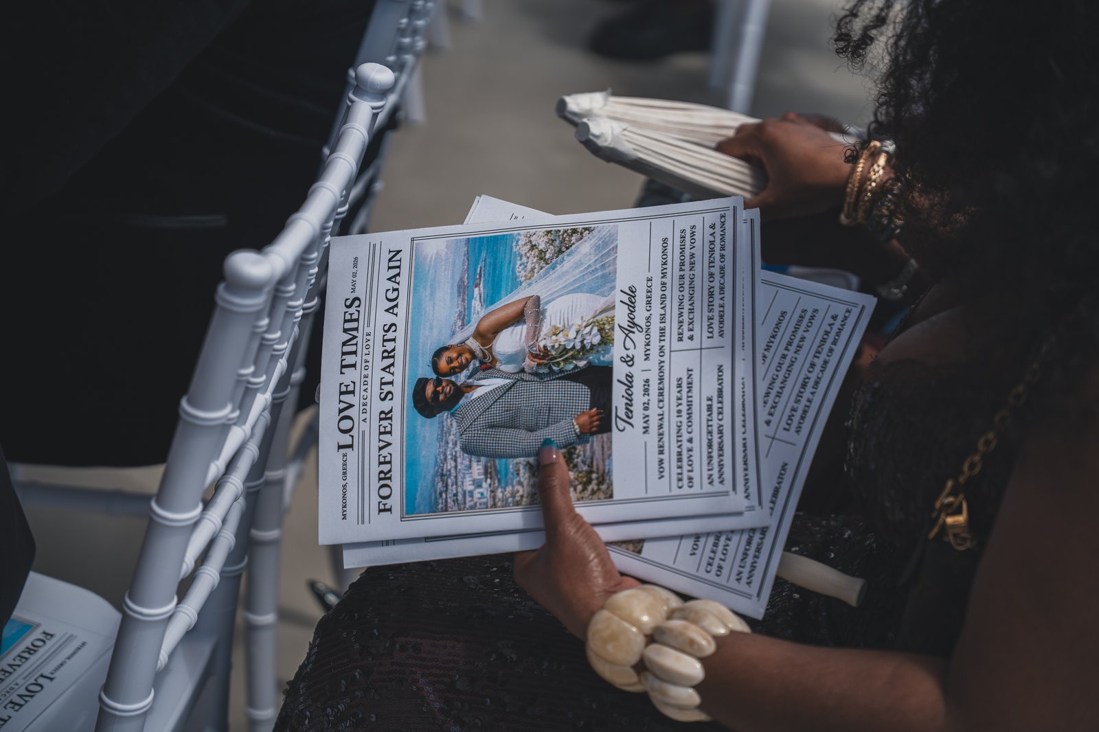 A guest reading the vow renewal program card