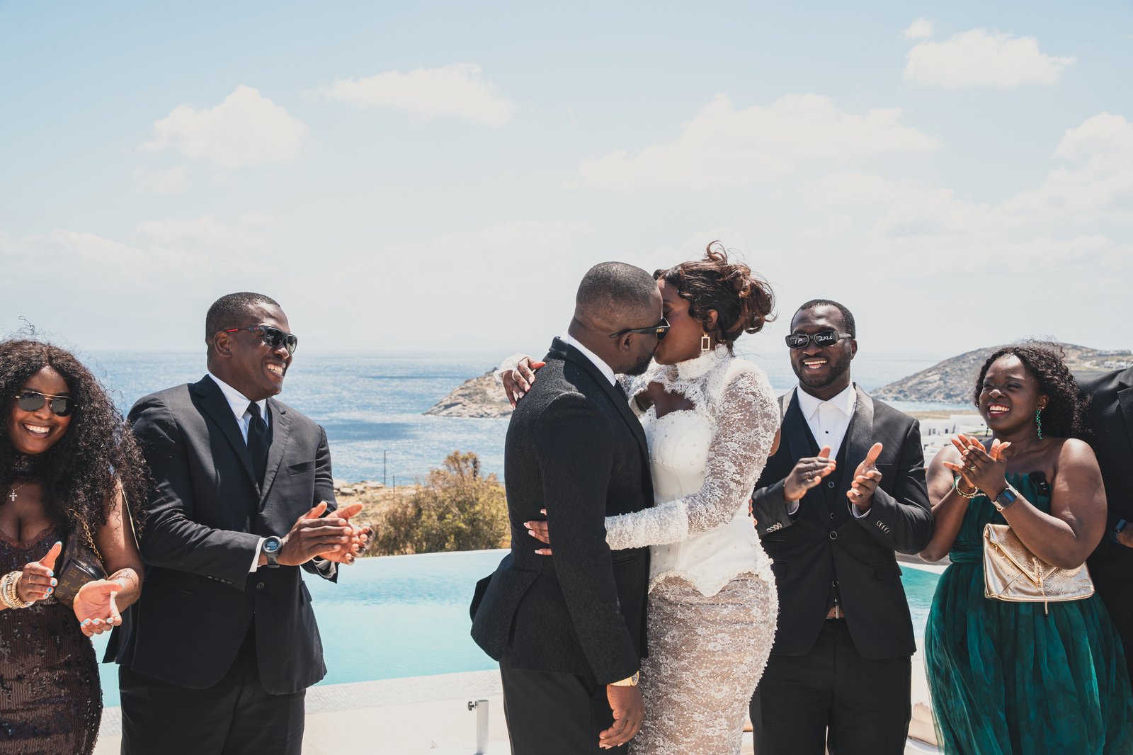 Guests applauding as the couple shares a celebratory moment