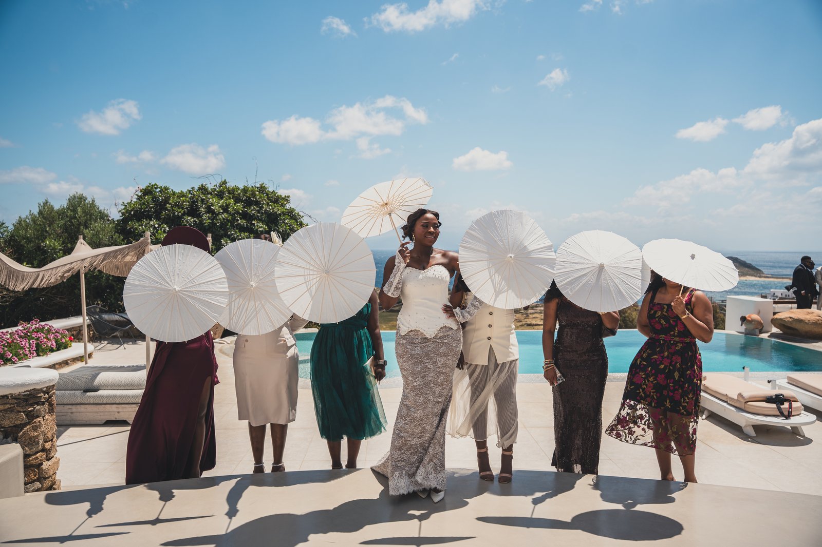 Bridesmaids twirling white parasols in celebration