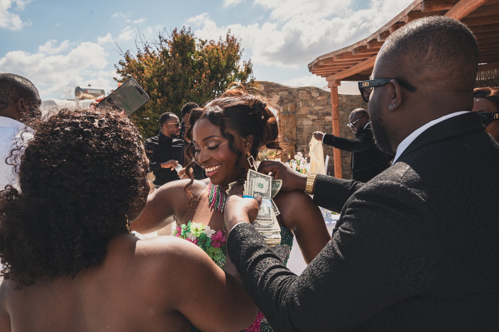 The bride and groom sharing a joyful embrace as guests celebrate around them