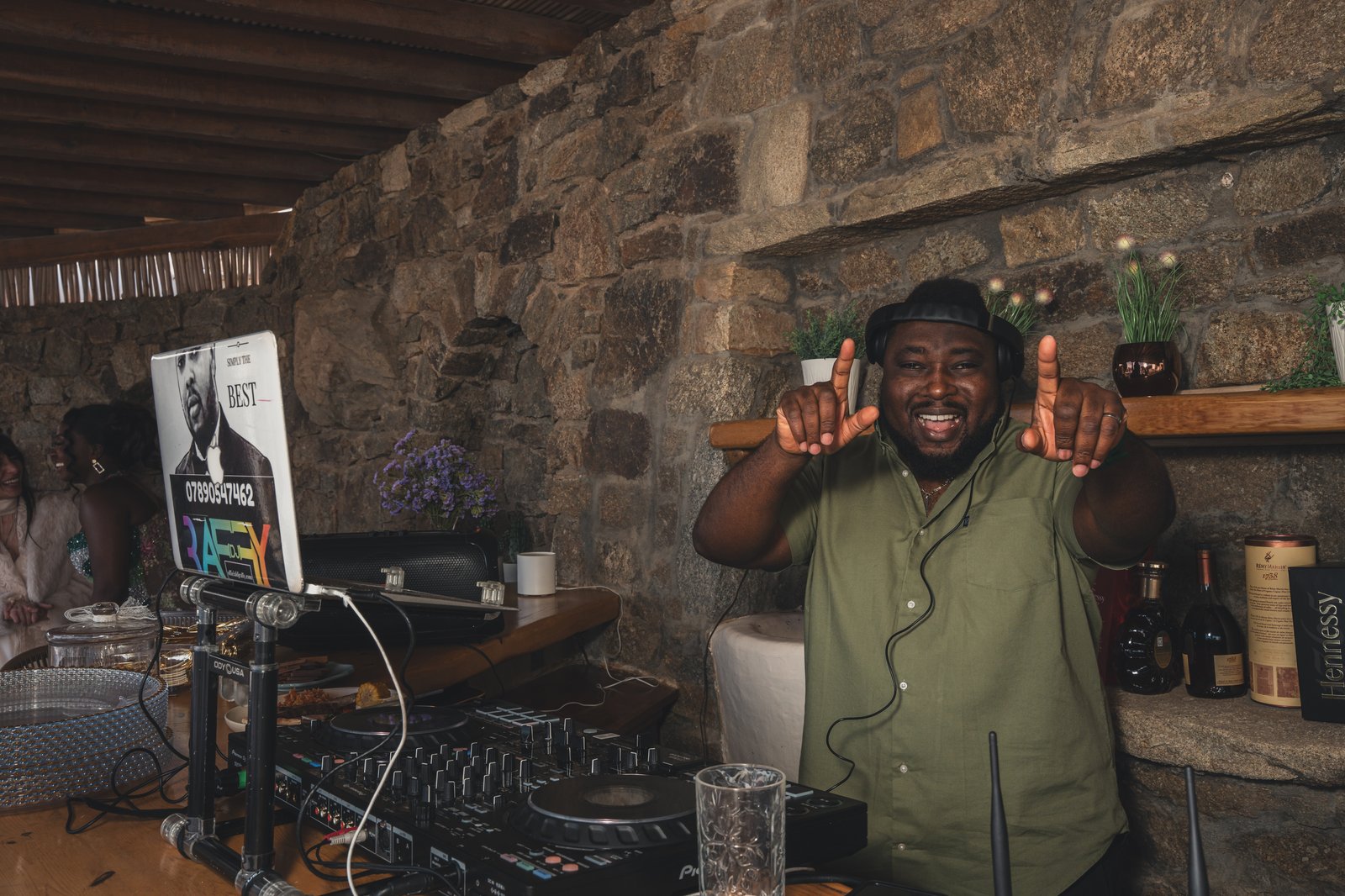 The DJ smiling behind the turntables at the reception