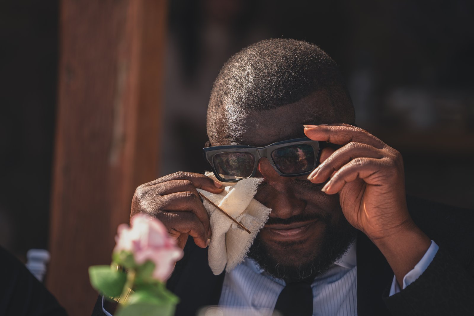 A guest wiping away happy tears during the ceremony
