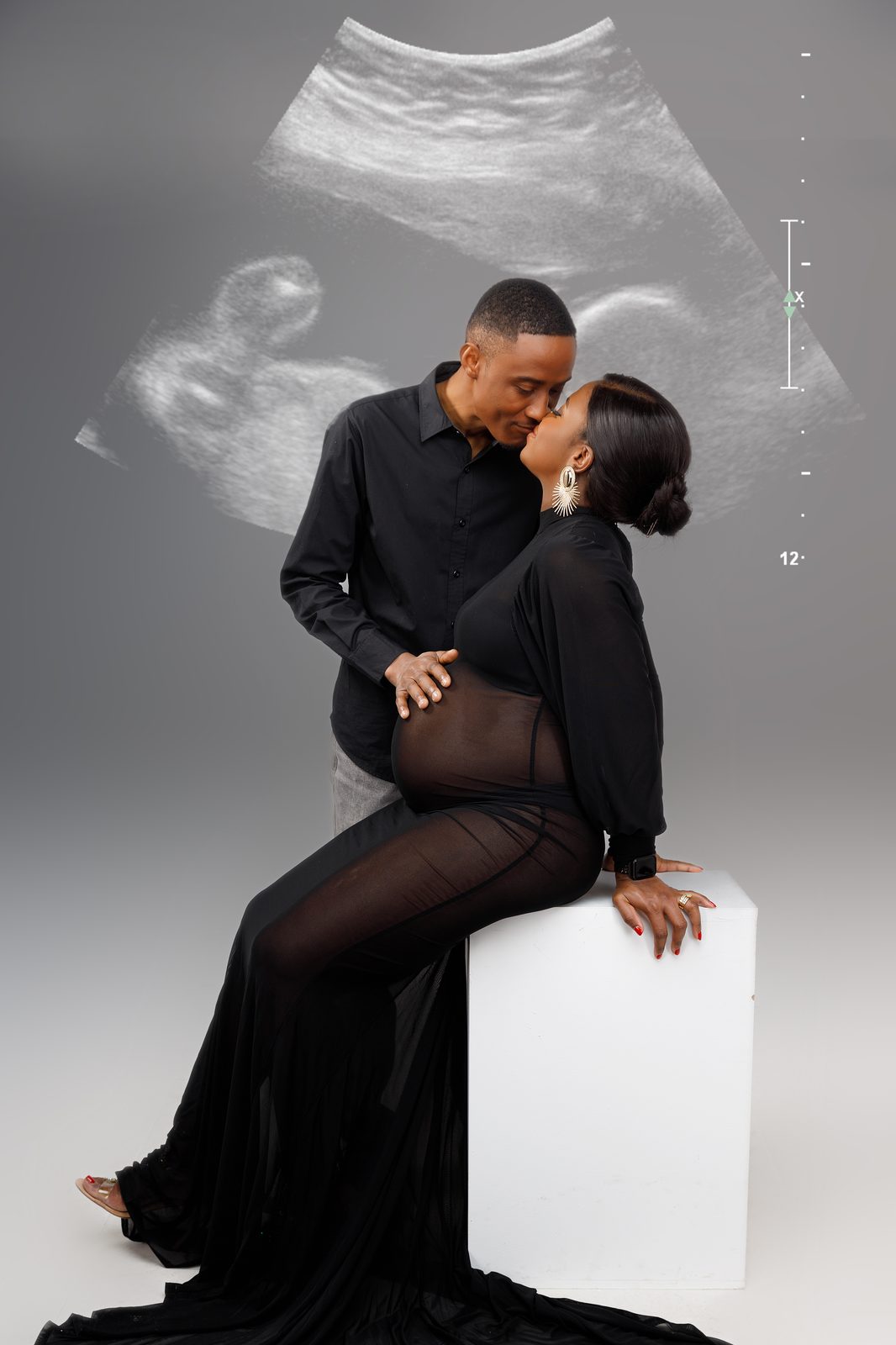 The couple embracing in front of an ultrasound-inspired backdrop