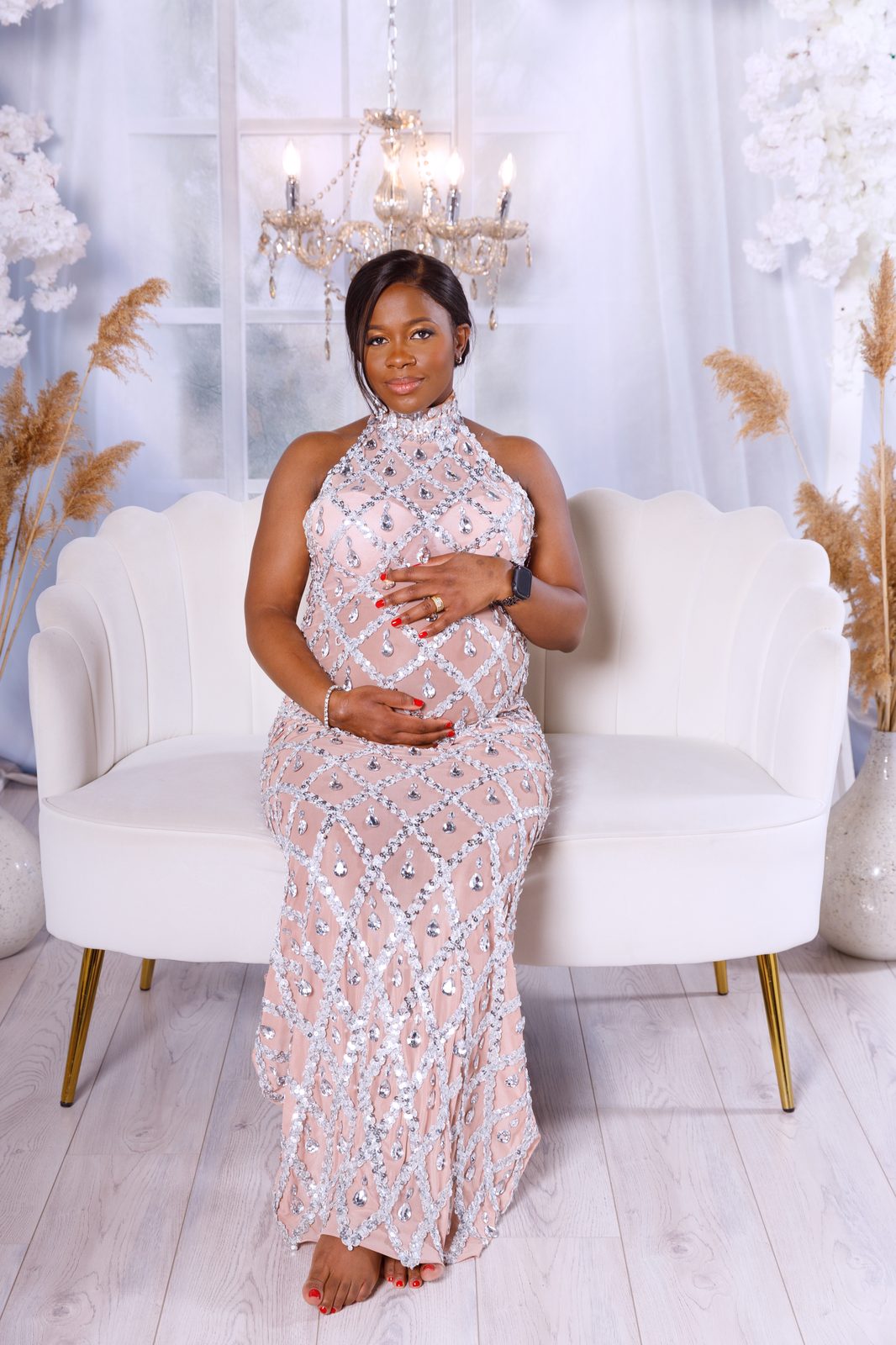 Portrait in a sequined blush gown on a velvet settee