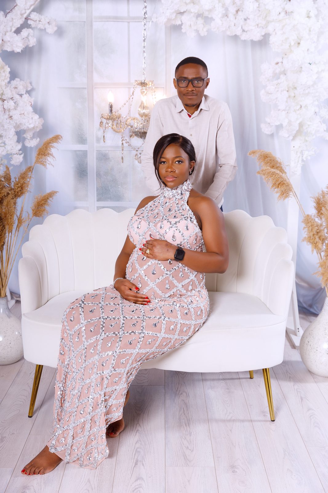 Family portrait beneath a crystal chandelier
