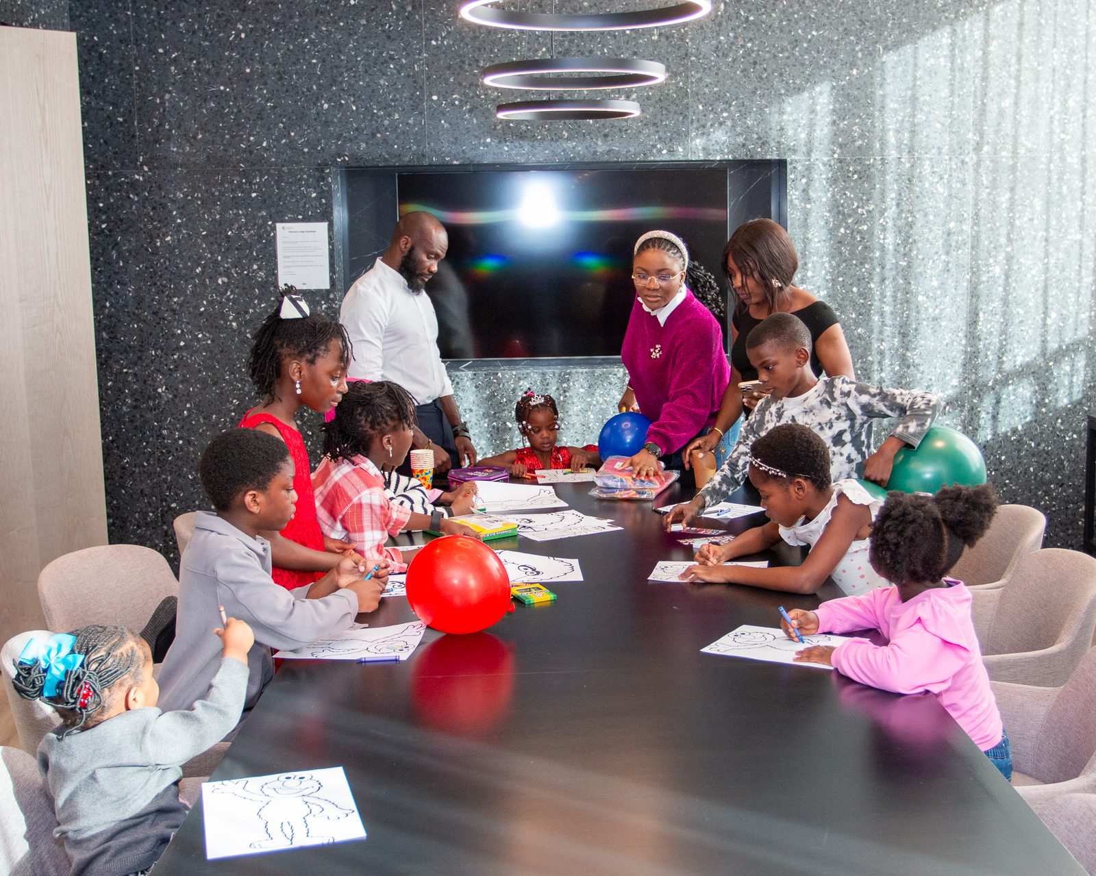 Children coloring together at the party table