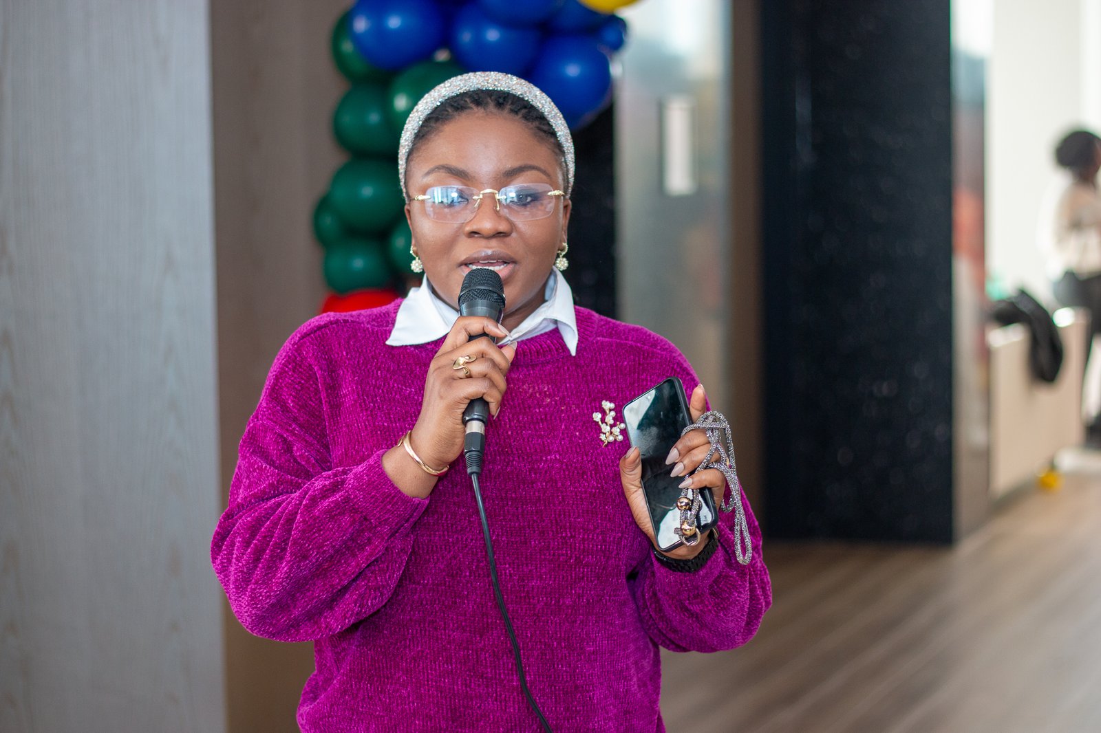 The host speaking into a microphone during the party