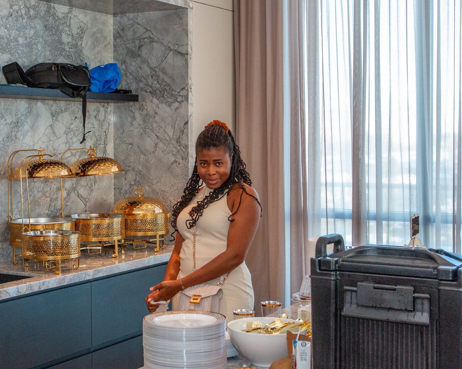 A guest arranging gold serving dishes at the buffet