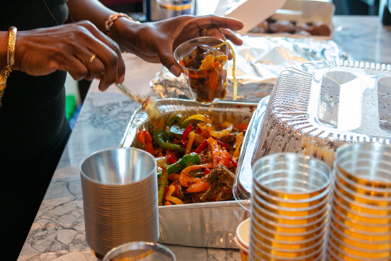 A close-up of food being served from a chafing dish at the buffet